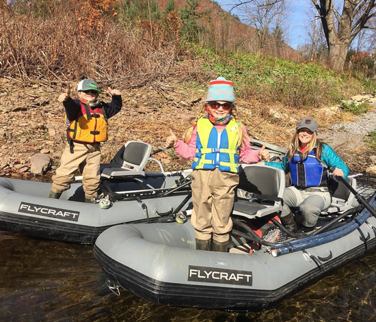 PHOTO PROVIDED (top) and ASSOCIATED PRESS FILE PHOTO (above) At top, Amidea Daniel fishes with her children, 6-year-old Logan and 8-year-old Evangeline, on Pine Creek in Lycoming County. Promoted to coordinator of youth and women's programs, Daniel is excited to design and implement a variety of initiatives for that demographic. Above, a woman practices the art of fly fishing, one of the programs in which Daniel already is experienced.
